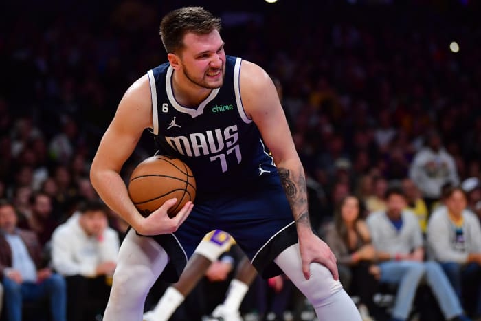 Dallas Mavericks superstar Luka Doncic grimaces after pulling down a rebound during the 2022-23 NBA season.
